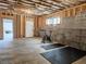 Unfinished basement featuring block walls, exposed wood beams, and open door at 5728 Williams Rd, Norcross, GA 30093