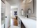 Modern bathroom with a white vanity, black faucet, and framed mirror in a well-lit space at 5728 Williams Rd, Norcross, GA 30093