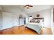 Primary bedroom features a vaulted ceiling, hardwood floors, and view to the ensuite bath and closet at 5728 Williams Rd, Norcross, GA 30093