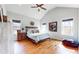 View of primary bedroom with vaulted ceilings, hardwood floors and windows at 5728 Williams Rd, Norcross, GA 30093