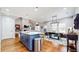 Open-concept living space with hardwood floors and dining area with modern chandelier lighting at 5728 Williams Rd, Norcross, GA 30093