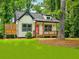 Inviting cottage-style home with cozy front porch and landscaped lawn at 5728 Williams Rd, Norcross, GA 30093