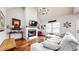 Bright living room featuring hardwood floors, a cozy fireplace, and high ceilings with modern chandelier at 5728 Williams Rd, Norcross, GA 30093