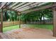 Backyard featuring a wooden deck and pergola with view into the wooded yard at 1245 Ladd Sw St, Atlanta, GA 30310