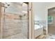 Bathroom featuring tiled stand-up shower, pebble floor, and soaking tub at 1245 Ladd Sw St, Atlanta, GA 30310