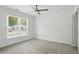 Bedroom features neutral carpet, overhead fan, and large window with neighborhood views at 1245 Ladd Sw St, Atlanta, GA 30310