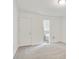 Bright bedroom features neutral carpet, white walls, and entrance to the Primary bathroom at 1245 Ladd Sw St, Atlanta, GA 30310