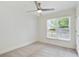 Bedroom featuring ceiling fan, neutral carpet, large window, and access to balcony at 1245 Ladd Sw St, Atlanta, GA 30310