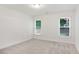 Bright bedroom with neutral carpet and two windows providing ample natural light at 1245 Ladd Sw St, Atlanta, GA 30310