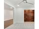 Bright bedroom featuring a ceiling fan, neutral carpet, and an accent wall made of wood at 1245 Ladd Sw St, Atlanta, GA 30310