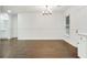 Spacious dining area with dark wood floors, white walls, and modern chandelier at 1245 Ladd Sw St, Atlanta, GA 30310