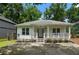 Charming one-story home with white siding, a covered porch, and a well-maintained front yard at 1245 Ladd Sw St, Atlanta, GA 30310