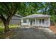 Charming white house features nice front porch and well-manicured yard at 1245 Ladd Sw St, Atlanta, GA 30310