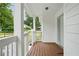 Inviting front porch with wood flooring and white railing, perfect for relaxing at 1245 Ladd Sw St, Atlanta, GA 30310