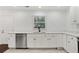 Bright kitchen featuring white cabinetry, stainless steel appliances, and tile floors at 1245 Ladd Sw St, Atlanta, GA 30310