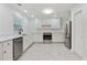 Bright kitchen with white cabinetry, stainless steel appliances, and tile floors at 1245 Ladd Sw St, Atlanta, GA 30310