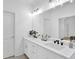 Bright bathroom features a dual sink vanity with white cabinetry and modern fixtures at 145 Millennial Ct, Lawrenceville, GA 30045