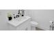Well-lit bathroom features a modern vanity, faucet, and sink with a tiled floor at 145 Millennial Ct, Lawrenceville, GA 30045