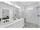 Modern bathroom features a dual sink vanity, subway tile, and a glass enclosed shower at 145 Millennial Ct, Lawrenceville, GA 30045