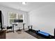 Bedroom features a window for natural light, desk, and an exercise machine at 145 Millennial Ct, Lawrenceville, GA 30045
