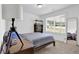 Bedroom featuring a window for natural light, wood furniture, and simple decor at 145 Millennial Ct, Lawrenceville, GA 30045