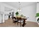 Bright dining area with hardwood floors and stylish lighting, offering seamless access to the kitchen at 145 Millennial Ct, Lawrenceville, GA 30045