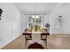Bright dining room features a dark wood table and a modern chandelier fixture at 145 Millennial Ct, Lawrenceville, GA 30045