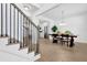 Elegant dining area with hardwood floors, wainscoting, and a modern chandelier, adjacent to the kitchen at 145 Millennial Ct, Lawrenceville, GA 30045