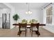 Bright dining room showcases a dark wood table with modern decor, with access to the kitchen at 145 Millennial Ct, Lawrenceville, GA 30045