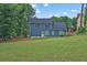 Well-maintained home exterior with a spacious backyard and large windows providing ample natural light at 145 Millennial Ct, Lawrenceville, GA 30045