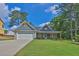 Charming single-story home featuring stone accents, a two-car garage, and a beautifully landscaped front yard at 145 Millennial Ct, Lawrenceville, GA 30045