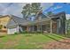 Inviting one-story home with a covered porch, two-car garage, and lush green lawn at 145 Millennial Ct, Lawrenceville, GA 30045