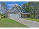 Beautiful one-story home with a two-car garage, stone veneer, and well-manicured lawn at 145 Millennial Ct, Lawrenceville, GA 30045