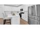 Well-lit kitchen features stainless steel appliances, a kitchen island and lots of cabinet space at 145 Millennial Ct, Lawrenceville, GA 30045