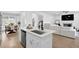 Modern open concept kitchen showcases an island with seating, flowing to dining and living spaces at 145 Millennial Ct, Lawrenceville, GA 30045
