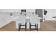 Charming kitchen features an island with seating, stainless steel appliances, and white cabinetry at 145 Millennial Ct, Lawrenceville, GA 30045