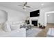 Bright living room with a fireplace, hardwood floors, recessed lighting, and a comfortable white sofa at 145 Millennial Ct, Lawrenceville, GA 30045