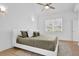 Bright main bedroom features a ceiling fan, and a large window for natural light at 145 Millennial Ct, Lawrenceville, GA 30045