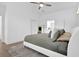 Bright main bedroom features ceiling fan, neutral color palette, and ensuite bathroom access at 145 Millennial Ct, Lawrenceville, GA 30045