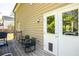 A quaint patio with chairs, a grill, and double doors that lead into the house at 2889 Carrousel Ct, Stone Mountain, GA 30087