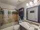 Well-lit bathroom showcasing a shower-tub combo with modern fixtures and neutral-colored tiles at 2889 Carrousel Ct, Stone Mountain, GA 30087