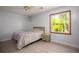 Cozy bedroom features a large window offering a view of the outdoors and neutral tones throughout at 2889 Carrousel Ct, Stone Mountain, GA 30087