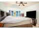 Spacious bedroom with a large window, a ceiling fan, and ample space for relaxation and storage at 2889 Carrousel Ct, Stone Mountain, GA 30087
