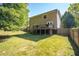 Spacious backyard featuring a deck with stairs, level lawn, and wood fence at 2889 Carrousel Ct, Stone Mountain, GA 30087