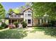 Charming two-story home featuring a welcoming porch and lush landscaping at 2889 Carrousel Ct, Stone Mountain, GA 30087