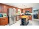 Spacious kitchen featuring stainless appliances, wood cabinets and a center island at 2889 Carrousel Ct, Stone Mountain, GA 30087