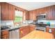 Well-equipped kitchen with stainless steel appliances and wood cabinets at 2889 Carrousel Ct, Stone Mountain, GA 30087