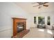 Bright, spacious living room with a fireplace, large windows, and hardwood floors at 2889 Carrousel Ct, Stone Mountain, GA 30087