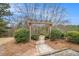 A stone walkway passes under an arbor and past landscaping to enter the neighborhood at 5621 Cobblestone Creek Ave # 14, Mableton, GA 30126