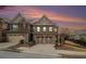 Beautiful two-story brick home featuring a two-car garage and a well-maintained front yard against a colorful sunset sky at 5621 Cobblestone Creek Ave # 14, Mableton, GA 30126